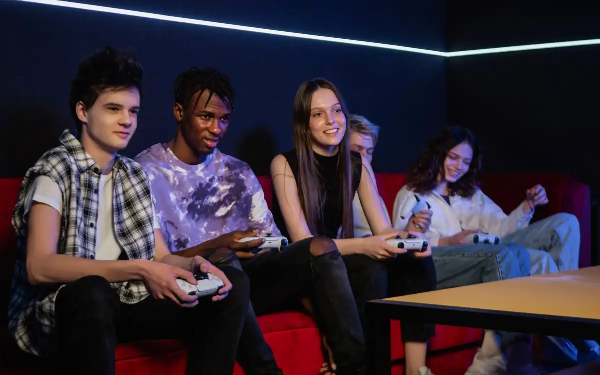 Group of friends gaming together on a red sofa – PHFUN community