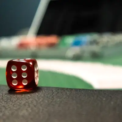 Sic Bo: red die on a casino table